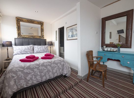Large en-suite sea view room with double bed and double sofa bed